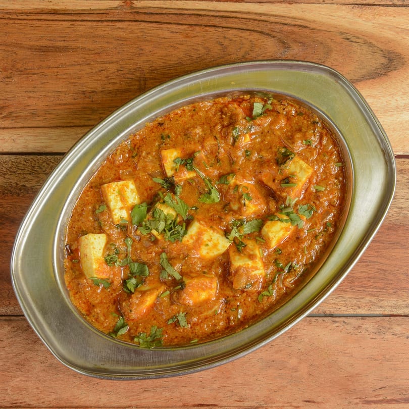 Tikka House Express's Paneer Butter Masala, a rich Indian curry with paneer cubes and fresh cilantro.